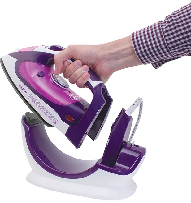 Quest 35070 220 Degree Max Cordless Steam Iron hand placing on the stand-min