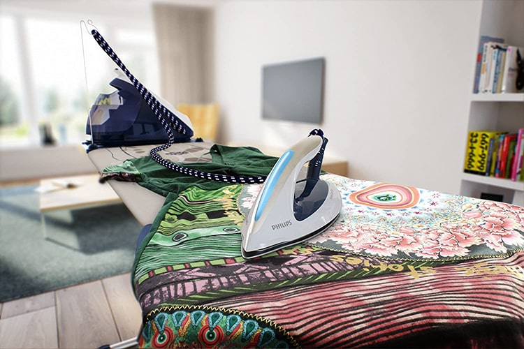 Philips PerfectCare Elite GC963020 on ironing board-min